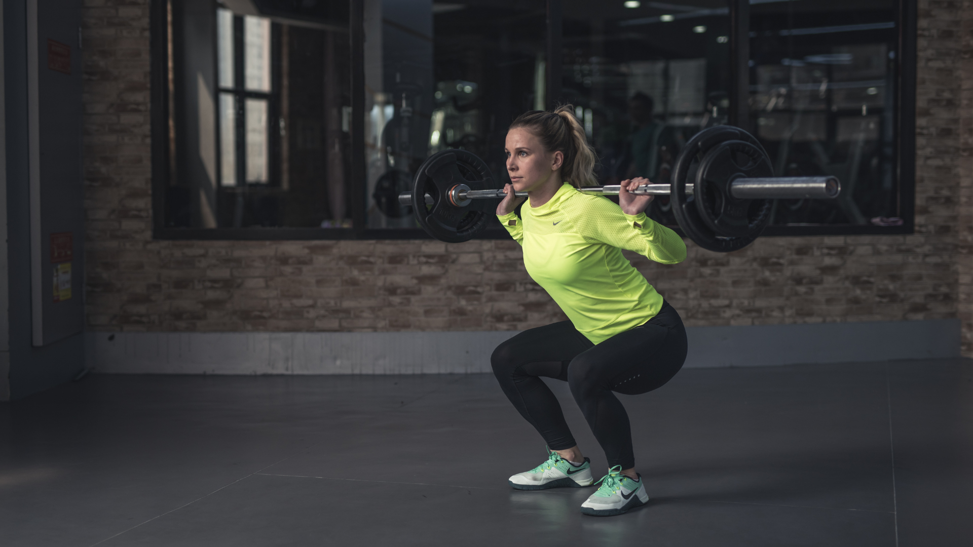 Woman performing a barbell squat.