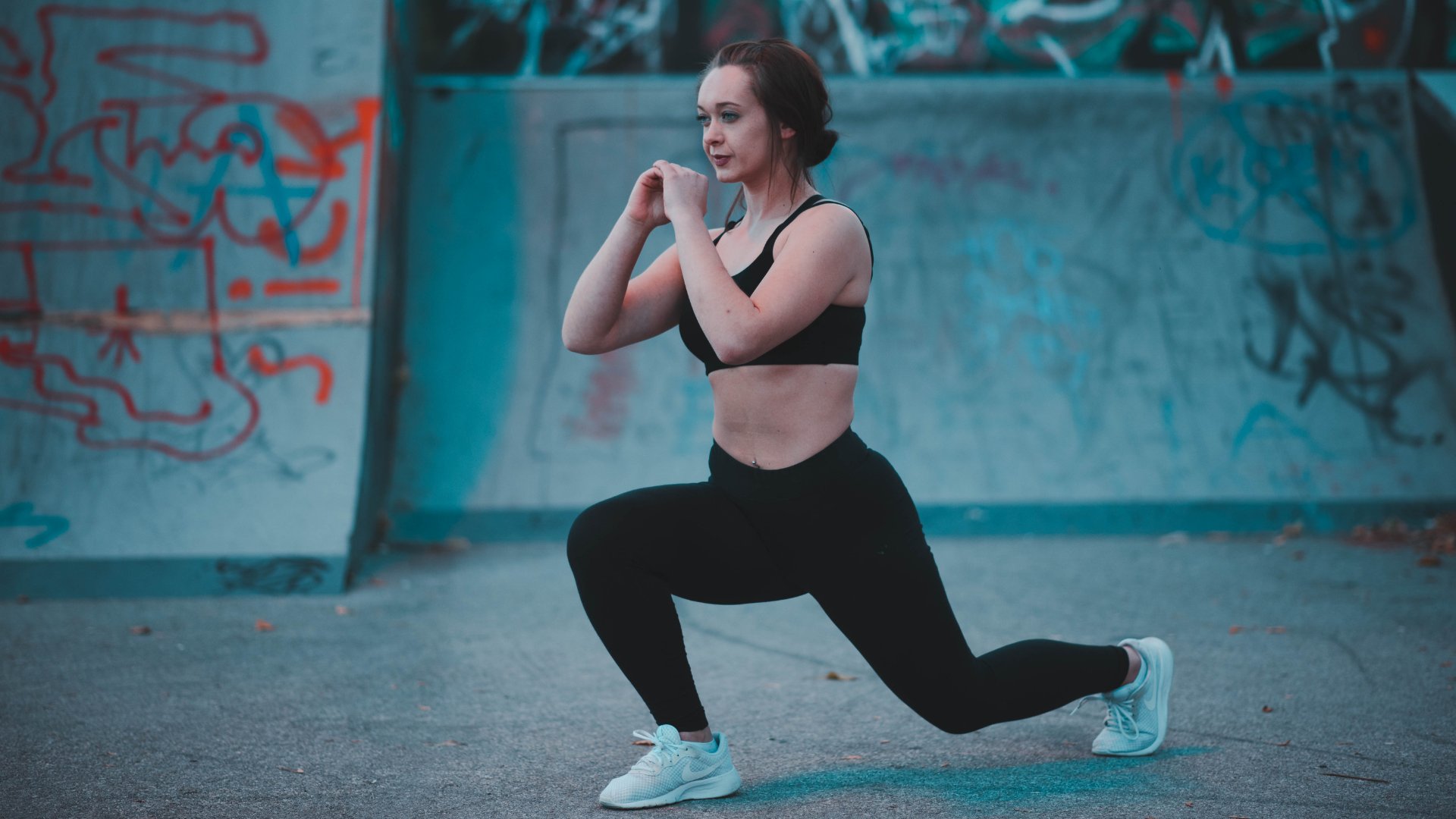 Woman doing a forward lunge.