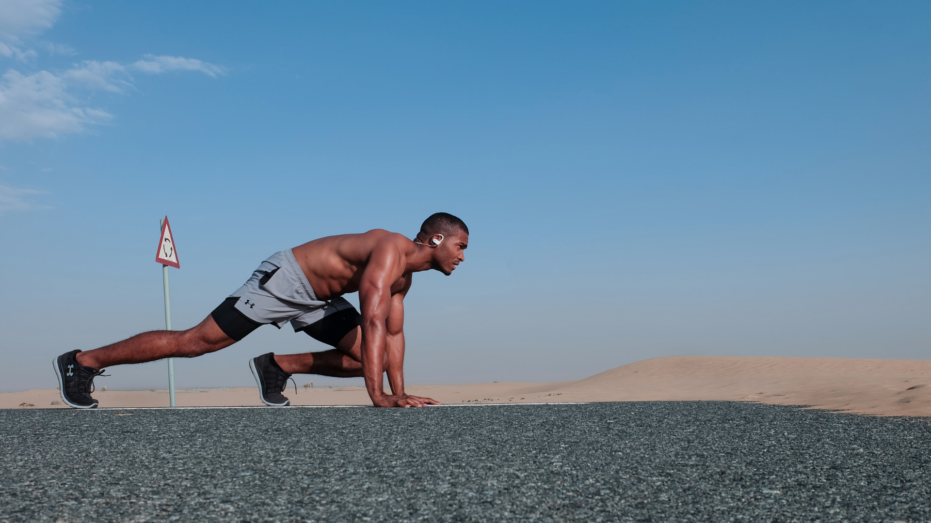 Man in a beginning race stance and to run.